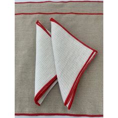 two red and white napkins sitting on top of each other