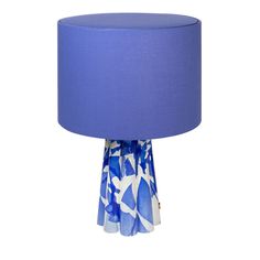 a blue and white table lamp with a blue shade on the top, in front of a white background