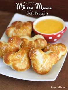 mickey mouse soft pretzels on a plate with dipping sauce