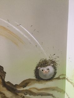 a hedgehog sitting on top of a tree branch in front of a wall mural