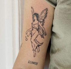 a tattoo on the arm of a woman with a small angel and name lumos