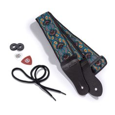 the guitar strap is being used to hold an electric guitar and other musical accessories, including a pair of scissors