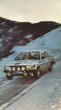 a car driving down a snow covered road