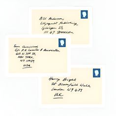 three envelopes with writing on them sitting next to each other