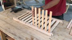 a man working on some kind of wooden structure that is being made out of wood