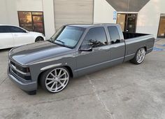 a gray truck parked in front of a building