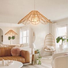 a living room filled with furniture and hanging lights