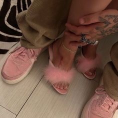 a person with pink shoes and tattoos on their feet