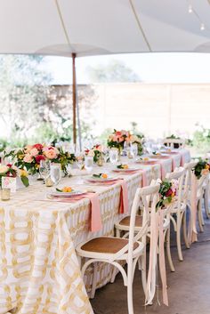 the tables are covered with pink and yellow tablecloths