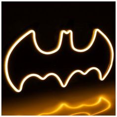 a blurry image of a batman symbol in the dark with light streaks on it