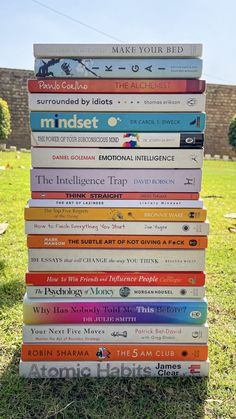 a stack of books sitting in the grass