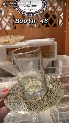 a person holding up a glass on top of a plate with the words booth 46