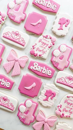 some pink and white decorated cookies on a table