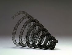 an artistic sculpture made out of black wire