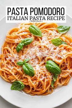 pasta with basil and parmesan sauce on a white plate, text overlay reads pasta pomodoro spaghetti with tomato sauce