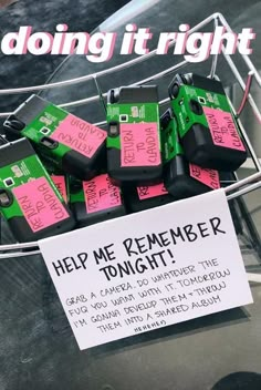 there is a sign that says help me remember tonight with pink and green tags on it