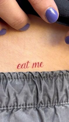 a woman's stomach with the word eat me written on it and her left side