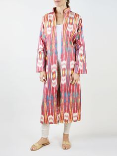 Our classic caftan duster. Inspired by the caftan garments of Uzbek royalty, the Fergana is designed with livable luxury in mind. Slits on the sleeve and the body of the caftan are created to highlight the jewelry and clothing that is worn underneath. Mandarin collar Sleeve and side slits Matching waist tie 100% silk ikat handwoven in Tashkent, Uzbekistan Tailored in Istanbul, Turkey Dry clean only Multicolor Ikat Print Long Sleeve Kaftan, Long Sleeve Multicolor Ikat Print Kaftan, Multicolor Long Sleeve Ikat Print Kaftan, Multicolor Long Sleeve Kaftan For Daywear, Fitted Multicolor Long Kaftan, Multicolor Fitted Long Kaftan, Fitted Long Multicolor Kaftan, Traditional Fitted Kaftan With Kimono Sleeves, Fitted Multicolor Kaftan With Kimono Sleeves