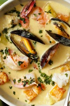 a white bowl filled with seafood and grits