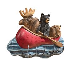 three bears are riding in a boat with an antler on it's back