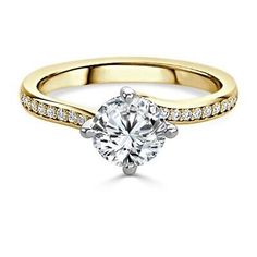 a yellow gold engagement ring with diamonds on the band and a round cut diamond in the center