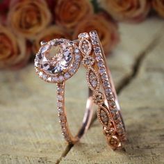 two rose gold wedding rings with diamonds on the top and bottom, sitting next to each other