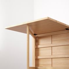 a wooden shelf with drawers underneath it