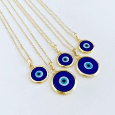 Ward off bad vibes in style with our Blue Turkish Evil Eye Necklace. Perfect for any occasion (except maybe a séance), this necklace features a stunning blue evil eye charm on a delicate chain. Keep the negativity away, all while looking fabulous. This necklace is combination of; - dark blue glass evil eye bead - stainless steel gold chain 15mm Charm Made in Turkey Blue Pendant Charm Necklace With Adjustable Chain, Blue Evil Eye Charm Necklace, Blue Evil Eye Pendant Necklace, Spiritual Blue Charm Necklace, Blue Pendant Charm Necklaces For Spiritual Style, Evil Eye Charm Necklace With Round Pendant, Blue Amulet Charms Necklace, Blue Amulet Jewelry With Adjustable Chain, Nickel Free Blue Amulet Necklace