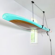 a surfboard hanging from the ceiling in a room