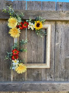 a wooden fence with a frame decorated with flowers