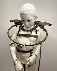 a white female mannequin with metal parts on it's arms and legs