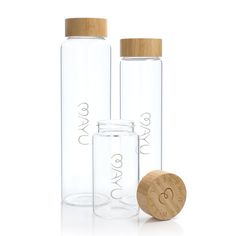 three clear glass bottles with wooden lids