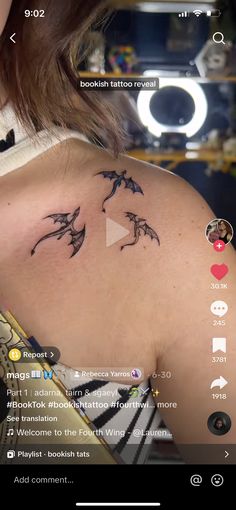 the back of a woman's shoulder with birds on it and an arrow in the middle