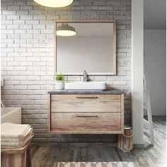 a bathroom with a sink and mirror on the brick wall next to a bathtub