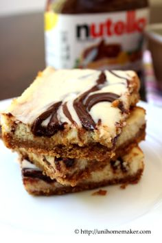 two pieces of cake sitting on top of a white plate next to a jar of nutella