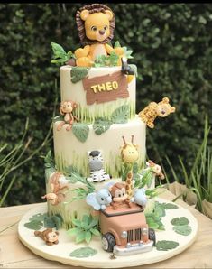 a three tiered cake with animals on it