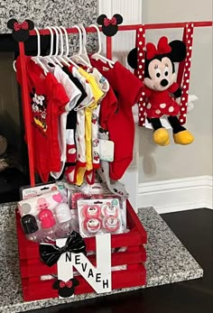 a mickey mouse themed baby's closet with clothes and toys