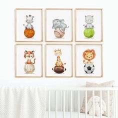 a baby's room with four framed pictures on the wall