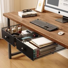 a computer desk with two drawers and a keyboard, mouse and books on it in front of a monitor