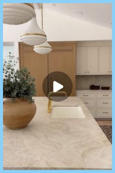 a kitchen counter with a bowl on top of it next to a potted plant