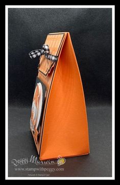 an orange bag with a bow on it