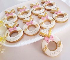 decorated donuts are arranged on a platter with pink bows and gold letters that spell out the word joy