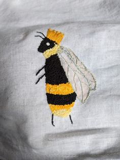 a close up of a piece of clothing with a bee on it