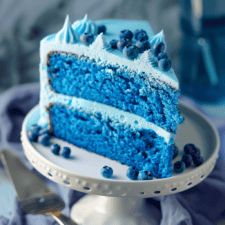 a slice of blue cake on a plate