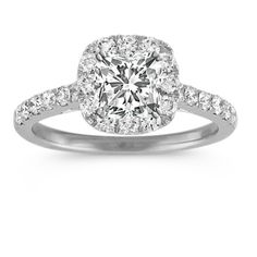 a cushion cut diamond ring with pave set shoulders