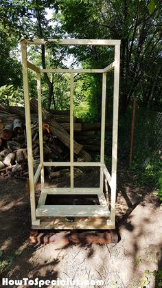 a wooden structure sitting on top of a pile of wood