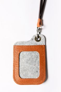 a leather and felt keychain hanging from a lanyard with a tag attached to it