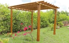 a wooden pergola in the middle of a yard