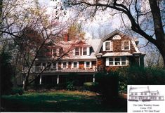 an old house with lots of windows and balconies on the second story is surrounded by trees