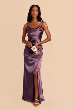 a woman in a purple dress posing for the camera